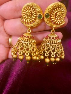 This traditional Green Ruby Antique Jhumki adds a touch of elegance to any Indian outfit. Handcrafted with intricate details, its vintage design is sure to make a statement. Elevate your style with this unique and timeless piece. Length - 6 cm Jewellery Care- Keep the jewelry dry, avoid heat and contact with perfumes & water. Brass Jhumkas For Festivals And Celebrations, Festival Brass Jhumkas For Celebrations, Traditional Heavy Jhumkas For Festive Occasions, Brass Jhumkas With Intricate Design For Wedding, Heavy Brass Jhumkas For Wedding, Wedding Brass Jhumkas With Tilla Detail, Wedding Brass Jhumkas With Intricate Design, Wedding Jhumkas With Intricate Brass Design, Traditional Bridal Earrings With Intricate Design For Navratri