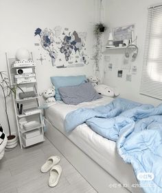 a bedroom with white walls and blue bedding