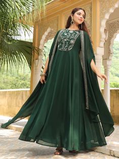 Grab this beautiful 2-piece set. The set comes with embroidered anarkali kurta has round neck, sleeveless & ankle length teamed with a flared cape 2 Piece Set Color - Dark Green Kurta Fabric-Georgette Kurta Length - 55 inches Cape Length - 36 inches Neck-Round Neck Kurta Sleeves-Sleeveless Cape Sleeves - Short Flared Work -Embroidery Detailing DISCLAIMER - The color of the product may be differ due to screen settings of device. A misprint here and a color drop slip there is the beauty of printin Georgette Anarkali, Dress With Cape, Embroidered Anarkali, Dark Green Dress, Kurta Dress, A Line Kurta, Anarkali Kurta, Anarkali Dress, Kurta With Pants