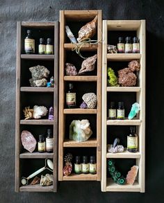 two wooden shelves filled with different types of rocks and other items on display next to each other