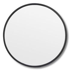 a black and white circular mirror on a wall