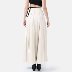 Step into effortless elegance with the Solace Vegan Leather Pleated Maxi Skirt in white. With a hidden zip closure and stylish golden embellishments, this skirt combines sophistication with a touch of luxury. The lightweight fabric drapes beautifully, offering a relaxed yet structured fit with just the right amount of stretch for comfort and durability. The vertical hand-pleating creates a flattering silhouette by elongating the lower body. Perfect for stylish occasions where comfort is key, thi Formal Long Cream Skirt, Elegant Cream Lined Skirt Bottoms, Elegant Lined Cream Skirt, Chic High-waist Beige Maxi Skirt, Chic Beige High-waist Maxi Skirt, Chic Beige High Waist Maxi Skirt, Luxury White Skirt For Spring, Elegant White Maxi Skirt For Work, Elegant White Pleated Skirt For Parties