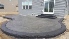 a concrete patio in front of a house