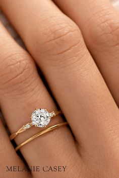 a woman's hand with a diamond ring on it