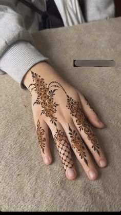 a person with henna tattoos on their hands