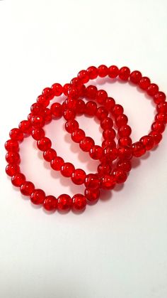 Set of 3 stretch bracelets made with 8mm red crackle glass beads on a sturdy elastic cord. Cheap Red Beaded Bracelets For Beach, Red Stretch Bracelet With 8mm Beads, Adjustable Red Stretch Bracelet With 8mm Beads, Casual Red Round Stretch Bracelet, Red Stretch Bracelet With 8mm Round Beads, Hypoallergenic Red Beaded Bracelets With Round Beads, Hypoallergenic Red Beaded Bracelets, Ramona Core, Red Crackle