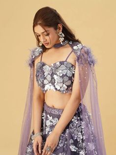 This Lehenga Choli is Ready to Wear Elevate your style with our Lavender Net Embellished Sequin Threadwork Floral Lehenga Set. This set features delicate sequin threadwork and intricate floral designs, making it a perfect choice for any special occasion. Crafted from high-quality net fabric, this lehenga set is both comfortable and stylish. Color Lavender Fabric Net Occasion Party Wear Wedding Wear Style Lehenga Choli Work Embroidery, Sequins Work Chest 38 Lehenga Length 45 NOTE - Originally sti Purple Sequined Dress For Diwali, Purple Sequined Sets For Party, Purple Sequined Party Sets, Purple Sequin Party Sets, Glamorous Embellished Sets For Navratri, Glamorous Sequined Choli For Eid, Glamorous Sequin Sets For Festivals, Purple Sequin Sharara For Diwali, Eid Sequinned Purple Sets