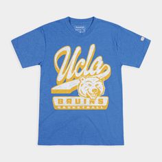 “Modern” Joe Bruin was a core athletic logo for UCLA from 1996 through 2003, since the Bruins wanted to give their mascot a contemporary look and feel to fit the times. He was a Joe of all trades, illustrated playing football and basketball to integrate him with the UCLA brand. We contrasted old and (relatively) new in this design by adding vintage touches to modern Joe, including a script UCLA used far before this Joe Bruin existed. Products are mocked up on a size S. Graphics may appear smalle College Throwback T-shirt With Team Logo, Throwback College T-shirt For Sports Season, Throwback T-shirt For College Sports Season, College Blue T-shirt With Team Logo, Blue Throwback T-shirt For Sports Season, Ucla Football, Athletic Logo, School Shirt Designs, Ucla Bruins