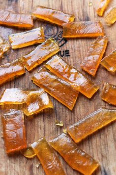 pieces of raw honey sitting on top of a wooden cutting board