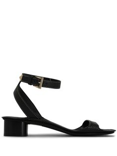 black calf leather triangle logo gold-tone hardware contrast stitching square open toe buckle-fastening ankle strap single toe strap branded footbed low block heel leather sole Calf Leather Sandals With Buckle Closure And Square Toe, Square Toe Calf Leather Sandals With Buckle, Leather Open Toe Heels With Gold-tone Hardware, Calf Leather Open Toe Heels With Gold-tone Hardware, Calf Leather Sandals With Gold-tone Hardware, Leather Sandals With Gold-tone Hardware For Evening, Evening Leather Sandals With Gold-tone Hardware, Gold-tone Open Toe Heels In Calf Leather, Gold-tone Open Toe Calf Leather Heels