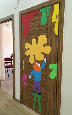 a child's door decorated with paper cutouts and colored paint on the doors