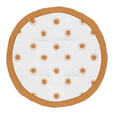 an orange and white round cushion with sun designs on it's sides, in front of a white background