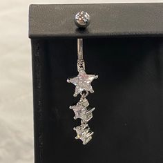 This Belly Button Ring Features A Silver Tone, With Three Star Shaped Jewels. Bellybuttonpiercing Y2k, Belly Button Piercing Waist Chain, Silver Star Belly Rings, Adjustable Silver Star Belly Ring, Belly Button Piercing Plus Size Women, Double Belly Button Piercing, Summer Belly Rings, Belly Button Piercing Cute, Belly Piercings