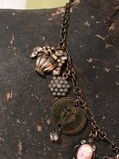 Vintage Charm Necklace With Round Pendant, Vintage Metal Jewelry With Dangling Charms, Vintage Handmade Medallion Charm Necklaces, Handmade Vintage Medallion Charm Necklaces, Antique Dangling Charms For Jewelry Making, Vintage Handmade Medallion Charm Necklace, Vintage Handmade Brass Charms, Handmade Vintage Brass Charms, Vintage Medallion Charm Necklaces