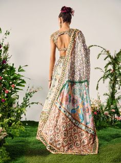 Elevate your elegance with this multi-paneled lehenga set, handcrafted with exquisite beadwork and intricate crystal embroidery on the waistband. The blouse boasts a sweetheart neckline with cap sleeves, finished with delicate tassels and dense beadwork. Comes with a matching dupatta. Crystal Embroidery, Sweetheart Neckline, Lehenga, Bead Work, Cap Sleeves, Custom Sizing, Tassels, Embroidery