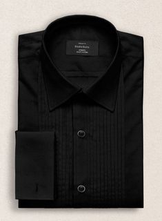 Create a timeless and elegant appearance. Our Pleated Black Tuxedo Shirt is a sophisticated choice for dress suits and tuxedos. Cut from the finest cotton, the shirt has a subtle luster and feel. Pleated bibs feature vertical pleats that run up both sides of the button placket and are a traditional detail on tuxedo shi Elegant Long Sleeve Dress Shirt For Semi-formal Occasions, Elegant Slim Fit Tuxedo For Semi-formal Occasions, Elegant Tailored Shirt For Work, Fitted Black Top For Formal Occasions, Fitted Tuxedo Shirt For Formal Occasions, Formal Fitted Tuxedo Shirt, Elegant Slim Fit Tuxedo For Formal Occasions, Elegant Slim Fit Dress Shirt For Party, Business Tuxedo Shirt With Long Sleeves