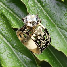 Our 15mm wide Hawaiian engraved tapered ring with 1.50 carat Cubic Zirconia is an original design we made back in 1996. The unique ring has pretty floral scroll cut-out pattern that has been handcrafted in 14K Gold-Glaze Silver. Please choose your ring size available in sizes 5, 6, 7, 8, 9, 10. This Hawaiian ring is sure to delight making a lovely gift for any occasion. Thank you for supporting local Hawaiian designers.  Enjoy free shipping to the continental USA from our Hawaii Factory. We do n Hawaii Ring, Hawaiian Ring, Hawaiian Heirloom Jewelry, Hawaii Gift, Heirloom Jewelry, Hawaiian Jewelry, Heirlooms Jewelry, Island Girl, Unique Ring