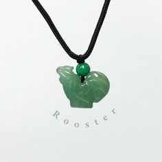 Meet the Jade Rooster Bracelet, a symbol of luck in the Chinese Zodiac. This bracelet features a rooster, intricately carved from pure jade, that perches elegantly on a delicate string necklace. It's more than just an accessory; it's a constant companion that embodies courage, love, and luck. With its simple elegance, this bracelet is perfect for daily wear. It effortlessly combines culture and style, attracting positive energy wherever you go. Don't miss out on this beautiful blend of tradition Adjustable Jade Necklace For Good Luck, Symbolic Black Necklaces For Good Luck, Black Jade Jewelry For Gifts, Attracting Positive Energy, Year Of Dragon, Love And Luck, Dragon Black, String Necklace, Jade Charm