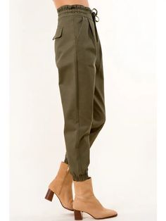 Tie Waist Paperbag Cotton Pants - Take your wardrobe up a notch with these Tie Waist Paperbag Cotton Pants in a trendy olive hue! Designed in LA, they're perfect for pairing with something unique from FABA's Wearable Art collection. Get your outfit ready and set to WoW! Ships from Los Angeles. Color: Olive Color: Olive Fabric: Details: Woven Cotton Pants Inseam: 26" Designed in and shipped from Los Angeles. Imported: Asia Fabric: 100% Cotton Care: Wash cold The lovely Model is wearing a size S. Green Parachute Pants With Elastic Waistband For Fall, Trendy Green Parachute Pants For Fall, Olive High-waisted Bottoms With Pockets, High-waist Olive Pants With Pockets, Olive High-waist Pants With Pockets, Olive Cargo Style Pants For Fall, Olive Cargo Pants For Fall, Chic Olive Pants For Spring, Khaki High-waisted Pants For Fall