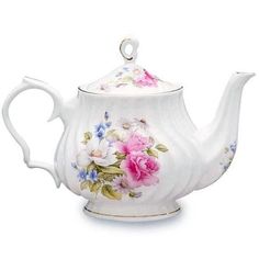 a white tea pot with pink and blue flowers painted on the side, sitting on a white surface