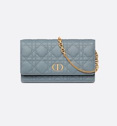 The Dior Caro pouch with chain is a practical and elegant creation. Crafted in cloud blue supple calfskin with Cannage stitching, it reveals an antique gold-finish metal CD signature flap and a compartment to hold all the essentials. The removable CD-link chain allows it to be carried by hand, worn over the shoulder or crossbody, thus making it an ideal daily companion.. Dior Caro Pouch, Dior Caro, Dior Star, Dior Book Tote, Christian Dior Couture, Wallet Pouch, Backpack Tote Bag, Silver Cufflinks, Beach Accessories