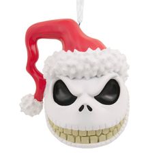 a christmas ornament with a skull wearing a santa hat