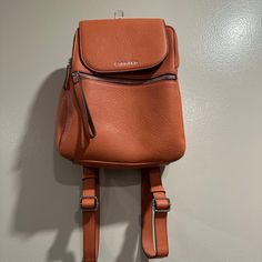 Never Used Orange Calvin Klein Mini Book Bag 5 Compartments Retails For $100 Open To Offers!! Leather Backpack With Cell Phone Pocket For School, Calvin Klein Travel Shoulder Bag With Removable Pouch, Calvin Klein Shoulder Bag With Removable Pouch For Travel, Calvin Klein Travel Shoulder Bag With Detachable Strap, Calvin Klein Satchel With Detachable Strap For Everyday, Calvin Klein Bags With Adjustable Strap, Calvin Klein Leather Bag For On-the-go, Calvin Klein Travel Bag With Removable Pouch, Calvin Klein Travel Satchel Shoulder Bag