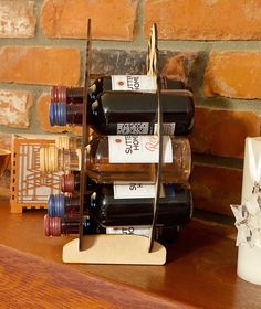 a wine rack with several bottles on it next to a candle holder and other items