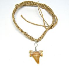 a necklace with an animal's head on it and a cord around the neck