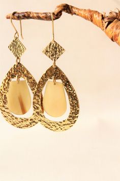 Handcrafted in Nairobi,Kenya! Crafted with brass and horn. Kindly note horn may be duller in person. Gold Plated Teardrop Pierced Earrings, Gold Plated Teardrop Pierced Jewelry, Pierced Teardrop Gold Plated Jewelry, Hypoallergenic Dangle Plug Earrings, Bohemian Pierced Linear Earrings As Gift, Teardrop Brass Hoop Earrings, Handmade Brass Dangle Chandelier Earrings, Teardrop Metal Clip-on Earrings For Gift, Gold Pendant Metal Earrings