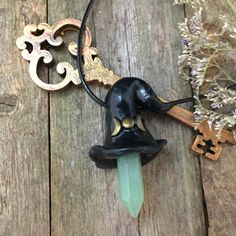 "🌛 QUICK DESCRIPTION 🌛 1 inch green Green Aventurine Crystal point 🌛 Made to order. Processing time 3-5 days 🌛 Polymer clay hand sculpted witches hat 🌛Hand painted 🌛 Size: 2\" x 1.5\" 🌛 Processing time: 1 week 🌛 19\" cord necklace adjustable to fit 17\" Wonderfully magical and whimsical, this little black witches with a green Dongling Jade/Green Aventurine crystal point. A unique gemstone necklace that will add something special to your outfit. Hand sculpted from polymer clay, into a cro Magical Black Necklace For Gift, Black Necklaces For Gifts, Whimsical Black Necklace For Gift, Handmade Magical Jewelry For Halloween, Handmade Magical Black Jewelry, Handmade Black Magical Jewelry, Mystical Halloween Necklace Gift, Mystical Necklace For Halloween Gift, Handmade Adjustable Witchy Necklaces