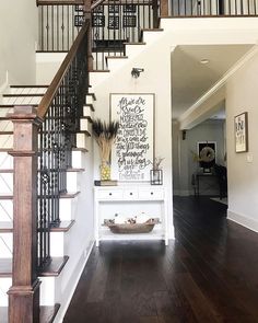 an entryway with stairs and wooden floors