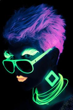 a woman with neon hair and sunglasses