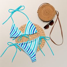 Stay comfortable and beach ready all summer in this FYC String Bikini set. It’s made from soft recycled polyester with double-layering and UPF 50+. Style the straps how you like, and get ready to swim! 🏊‍♀️ 🌟 Features: Soft and stretchy material with UPF 50+ protection. Available in sizes up to 4XL. Bikini top comes with removable padding for comfort. Multiple ways to tie and style the bikini set. 🌊 Disclaimer: To make your All-Over Print Recycled String Bikini last longer, thoroughly rinse i Beach Season Swimwear With Adjustable Straps And Tie-side Bottom, Adjustable Straps Tie-side Bottom Swimwear For Beach Season, Beachwear Swimwear With Uv Protection And Tie-side Bottom, Adjustable Summer Tankini For Swimming, Uv Protection Swimwear With Triangle Top For Swimming, Uv Protection Swimwear With Tie-side Bottom, Uv Protection Triangle Top Swimwear For Swimming, Uv Protection Tie-side Swimwear, Beachy Swimwear With Adjustable Straps For Sunbathing