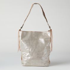 Leather Handbag - This fashionable tote displays a shimmering, silver surface and braided stitching details. Chic Silver Leather Bucket Bag, Chic Silver Hobo Tote Bag, Chic Silver Tote Hobo Bag, Chic Silver Bucket Bag With Silver-tone Hardware, Luxury Silver Leather Bucket Bag, Silver Bucket Bag With Silver-tone Hardware For Everyday Use, Metallic Shoulder Bag For Daily Use, Chic Silver Bucket Bag For Travel, Chic Silver Rectangular Hobo Bag