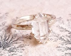 a close up of a ring on a table with snowflakes in the background