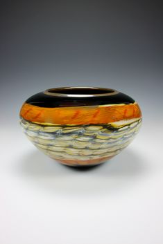 a black and yellow striped bowl sitting on top of a table