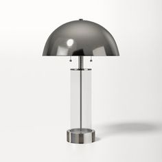 a lamp that is sitting on top of a table next to a white wall and floor