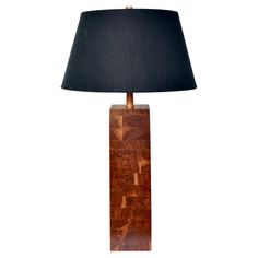 a wooden table lamp with a black shade on the base and a dark fabric lampshade