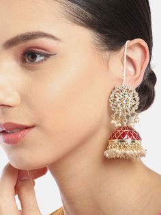 These beautiful maroon & off-white dome-shaped jhumka earrings come with kundan stone studs, beaded danglers, are gold-plated and are secured with a post and back closure. Comes with beaded detachable ear chains. These handcrafted jhumkas add just the right amount of elegance & oomph! to make those heads turn. The detachable 'chain just adds versatility! Product color may vary based on the monitor or screen you are using.See FAQ for more details. Size Length of earring: 8 cmLength of ear chain: Temple Jewelry Jhumkas With Dangling Beads For Festivals, Festival Jhumkas With Dangling Beads, Temple Jewelry Chandbali Jhumkas With Dangling Beads, Traditional Jhumkas With Dangling Beads For Diwali, Festive Kundan Jhumkas With Dangling Beads, Red Kundan Jhumkas, Bollywood Style Jhumkas With Dangling Beads, Kundan Jhumkas With Dangling Beads For Celebration, Traditional Chandbali Jhumkas With Dangling Beads