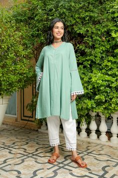 Stella green ash kurta with pant set is perfect for a festive season or a day out . Cotton cambric fabric makes it perfect for summer weather. Front diamond cut neckline with kurta hem lace give a classic look. Product has no lining. Pant has two side pockets, back elasted waistband and lace on the hem. Cold wash and Dry clean only.Type of Work: Solid Fit: Loose Model Height: 5'7 Measurements: Kurta- 41.5" Pant- 35.25" SKU#: 11702070GR Disclaimer: There may be slight difference in actual product Unstitched Cotton V-neck Kurta, Loose Kurta For Women, Green Anarkali Kurta For Summer, Green Cotton V-neck Set, Green Cambric Kurta For Summer, Green Cambric Kurta For Eid, Pista Green Cotton Lawn Suit For Summer, Summer Green Cambric Kurta, Summer Pista Green Cotton Lawn Suit