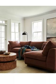 a living room with two couches and a coffee table in front of large windows