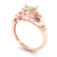 a yellow diamond engagement ring set in 18k rose gold with an oval cut center stone