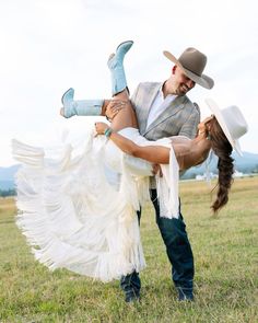 a man holding a woman on his back in a field