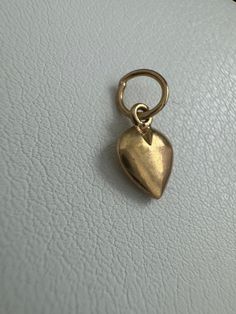 14k Vintage Heart Charm This 14k Vintage Heart Charm is a delicate and beautiful addition to any jewelry collection. The charm measures 13.6mm x 6.1mm and weighs 0.36 grams. This piece, like all our jewelry, is a unique find--once it's gone, it's gone--unlikely to be sourced again! Choosing this piece is a win-win: You'll stand out from the crowd & help the environment by shopping sustainably! Why You'll Love It:      Sweet Design: The heart shape adds a loving and sweet touch to your look. Help The Environment, Vintage Heart, Love Symbols, Gold Design, Memorable Gifts, Heart Shape, Heart Charm, Charm Necklace, Unique Pieces