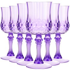 six purple glass goblets lined up in a row