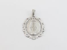 "fabulous 14k solid White Gold Virgin Mary Charm Pendant! * Material: 14k gold, Not plated or filled * Pendant Length: 1\" or 27 mm long not including the bail * Pendant Width: 7/8\" or 22 mm wide * Weight: 3.80 grams * Complementary Gift Box There is a prayer around Mary which says: O Mary conceived without sin pray for us who have recourse to thee. This Pendant is the same size as a quarter. Images may be enlarged to show detail and the item may look larger than it appears in person.In order t Elegant Silver Jewelry For Commemoration, Silver Miraculous Medal Jewelry For Wedding, Silver Miraculous Medal For Wedding, Silver Filigree Necklace In 14k Gold, White Gold Miraculous Medal Jewelry In Sterling Silver, White Gold Miraculous Medal Round Pendant, Elegant Round Miraculous Medal Jewelry, Engraved White Gold Jewelry For Commemoration, Elegant Miraculous Medal Jewelry