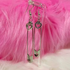 Take a fashionable risk with our Safety Pin Heart Earrings! These edgy earrings feature a heart charm attached to a safety pin, adding a cute and alternative touch to any outfit. Dare to be different and rock these unique earrings! Description: Item Type: EarringsEarring Type: Drop EarringsMetal Type: Iron AlloyOrigin: CNShape\Pattern: HeartMaterial: Metal Trendy Single Safety Pin Earring, Trendy Safety Pin Single Earring, Trendy Safety Pin Earrings For Pierced Ears, Punk Heart-shaped Earrings, Punk Heart-shaped Pierced Earrings, Edgy Heart-shaped Pierced Jewelry, Trendy Pins As A Gift, Trendy Pins For Gifts, Nickel Free Punk Style Earrings