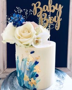 a white cake with blue and gold decorations