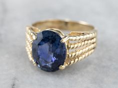 We love sapphires because they can be worn as special engagement pieces, or simply everyday rings! This particular sapphire is a sophisticated shade of cobalt blue, with a gorgeous sparkle and cool tones that contrast nicely with the warmth of the yellow gold. Rope accents add nice structural detail to the shoulders of the ring. Metal: 14K Yellow Gold Gem: Sapphire 3.27 Carats Gem Measurements: 8 x 10.1 mm, Oval Ring Size: 4.25 Marks: "14K SKAL" Stamped on the inside band Yellow Gold Sapphire Ring, Favorite Engagement Rings, Ring Sapphire, Gold Solitaire Ring, Cameo Ring, Sapphire Engagement Ring, Oval Ring, Everyday Rings, Oval Rings